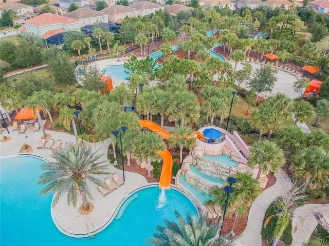 an aerial view of a swimming pool patio lake and outdoor seating
