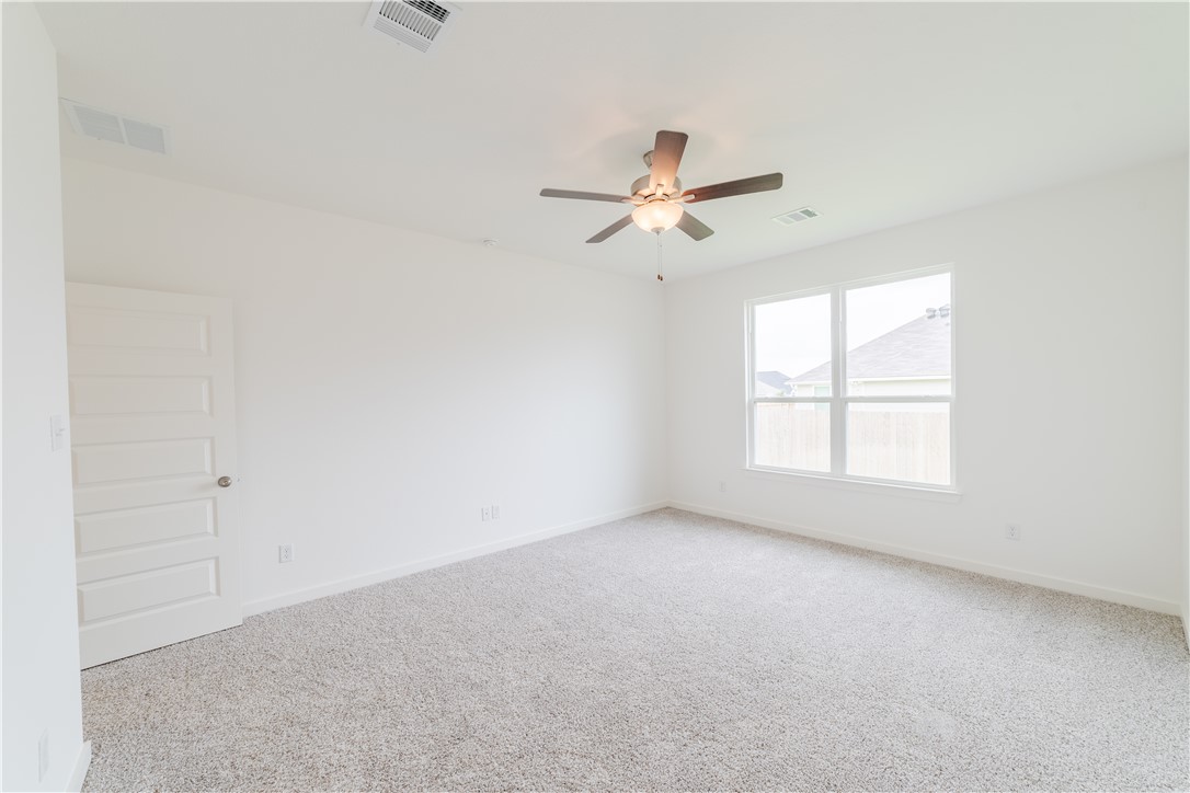 1901 Sebright Drive Bryan, TX 77807 - Photo 9 of 13 an empty room with a window and a ceiling fan