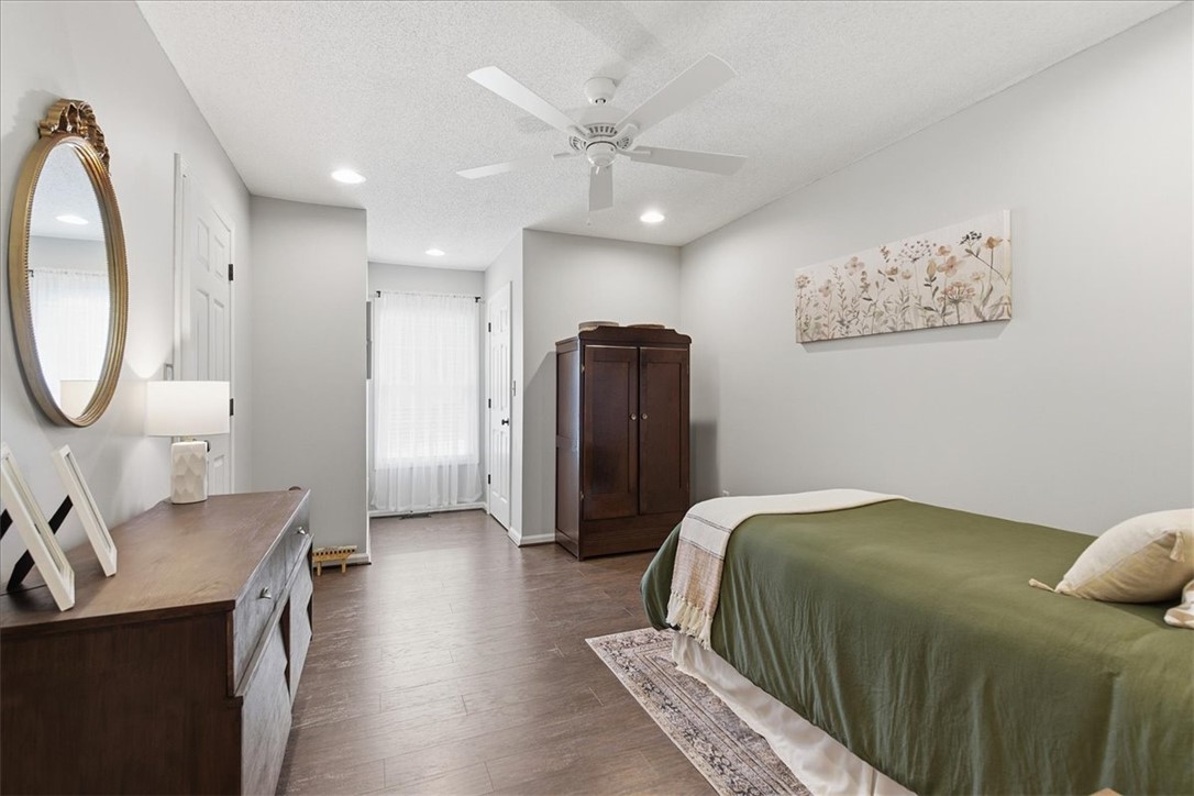 166 Amberwood Drive Anderson, SC 29621 - Photo 11 of 38 This inviting bedroom features rich wood flooring, bright recessed lighting, and a cooling ceiling fan.