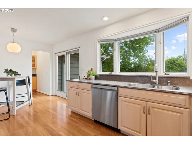 a kitchen with granite countertop a sink and a window