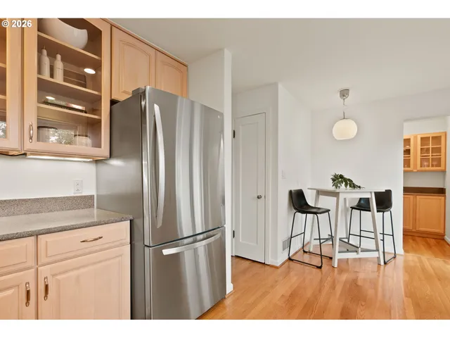 a kitchen with stainless steel appliances granite countertop a refrigerator and a stove top oven