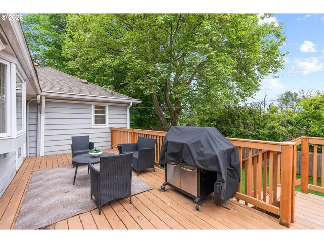 a view of a deck with table and chairs with wooden floor and fence