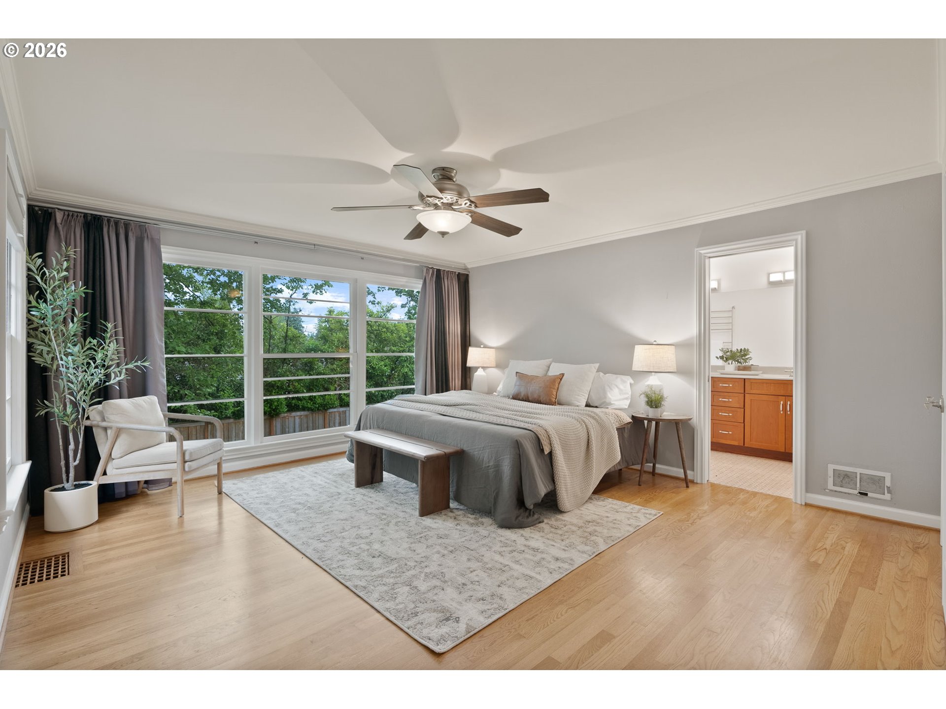 8120 Southwest Maple Drive Portland, OR 97225 - Photo 21 of 48 a spacious bedroom with a bed a couch and a large window