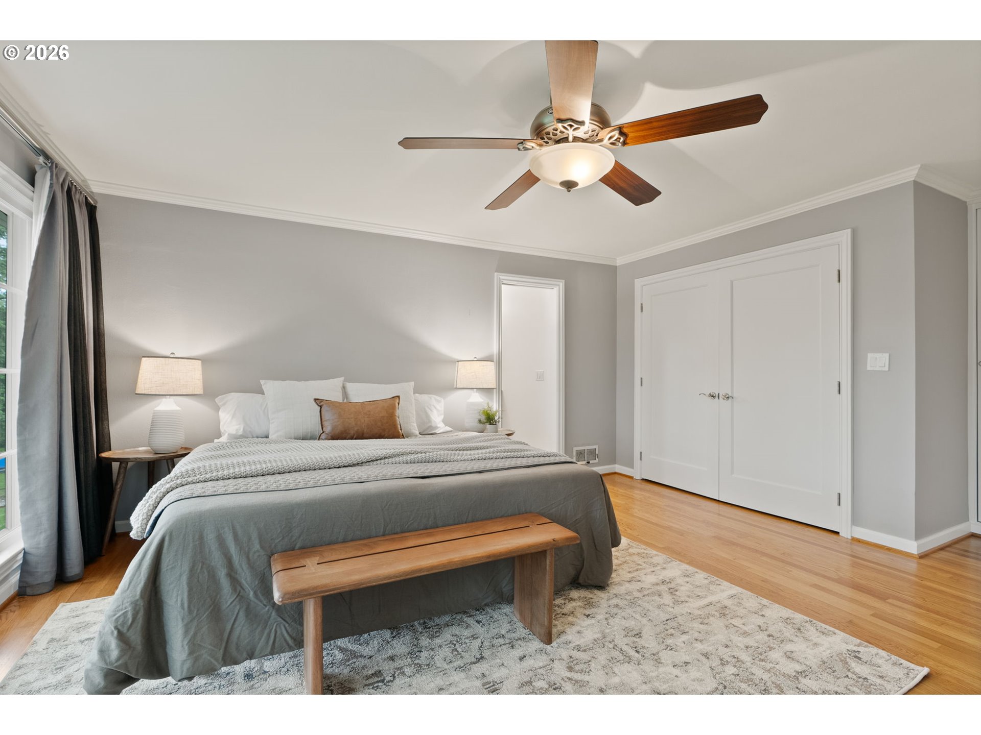 8120 Southwest Maple Drive Portland, OR 97225 - Photo 22 of 48 a bedroom with a bed and a chandelier
