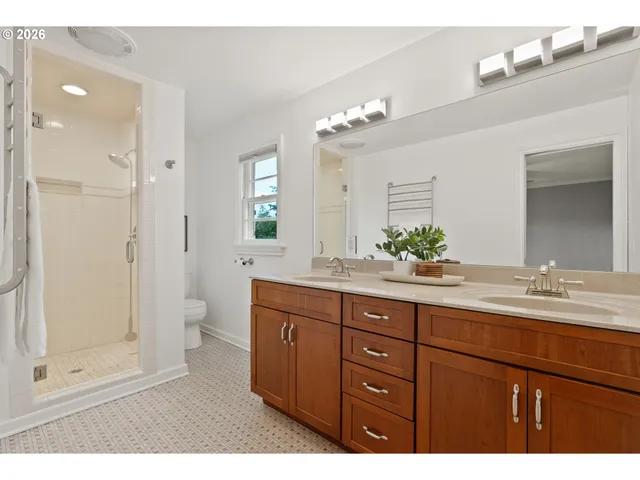a bathroom with a granite countertop sink mirror and shower