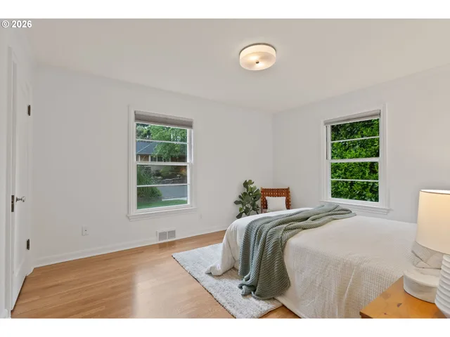 a bed sitting in a bedroom next to a window