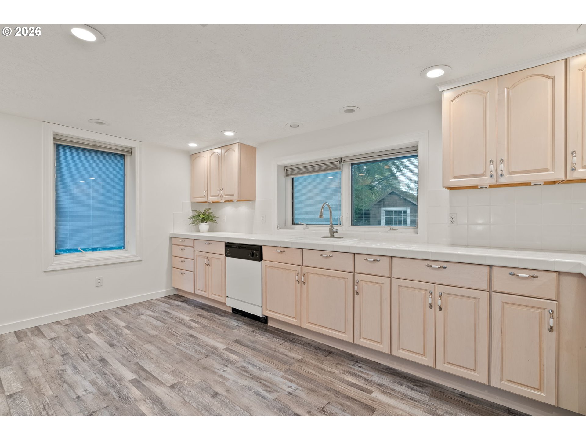 8120 Southwest Maple Drive Portland, OR 97225 - Photo 30 of 48 a kitchen with granite countertop white cabinets and white appliances