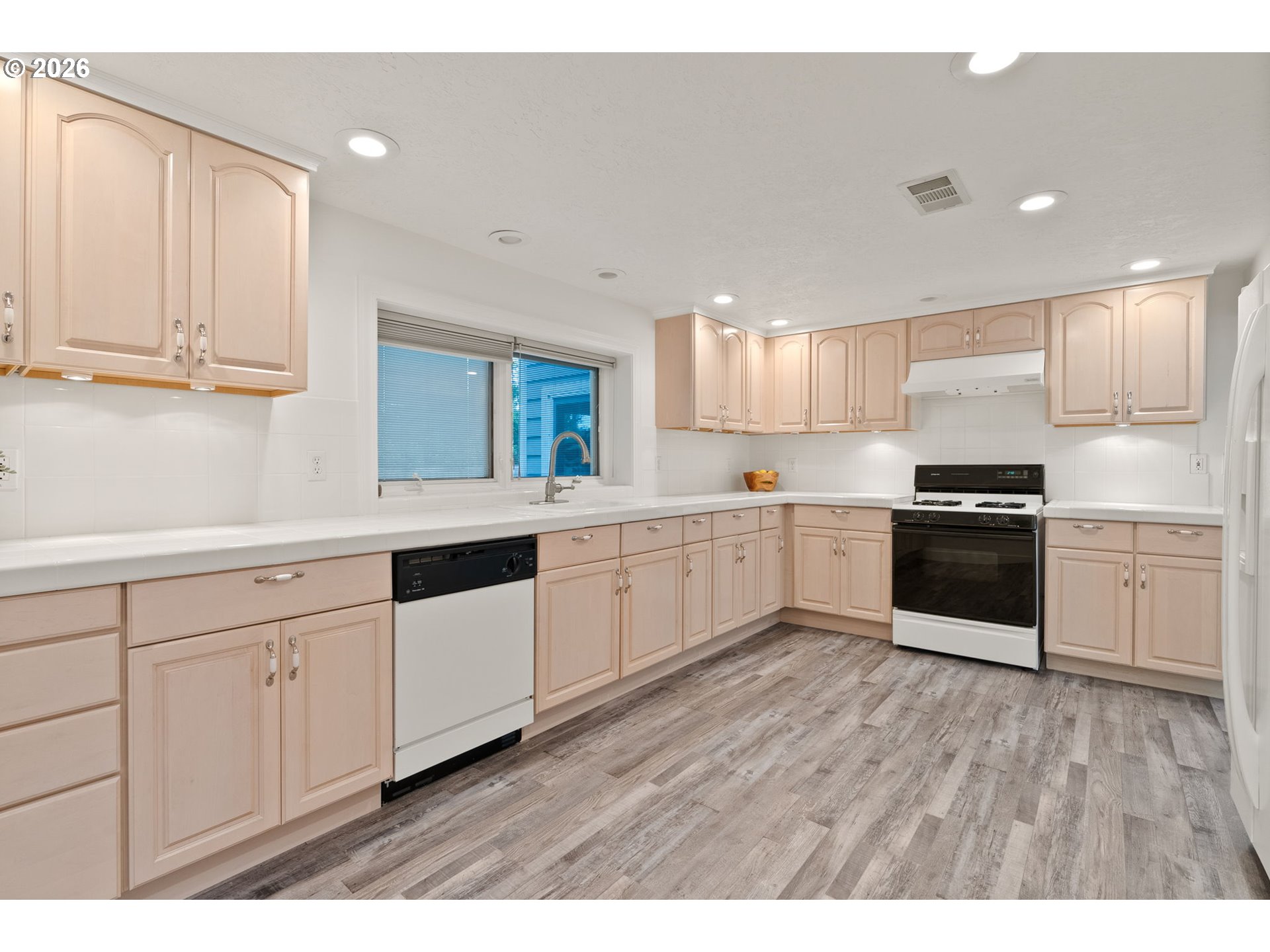 8120 Southwest Maple Drive Portland, OR 97225 - Photo 31 of 48 a kitchen with granite countertop white cabinets and white appliances