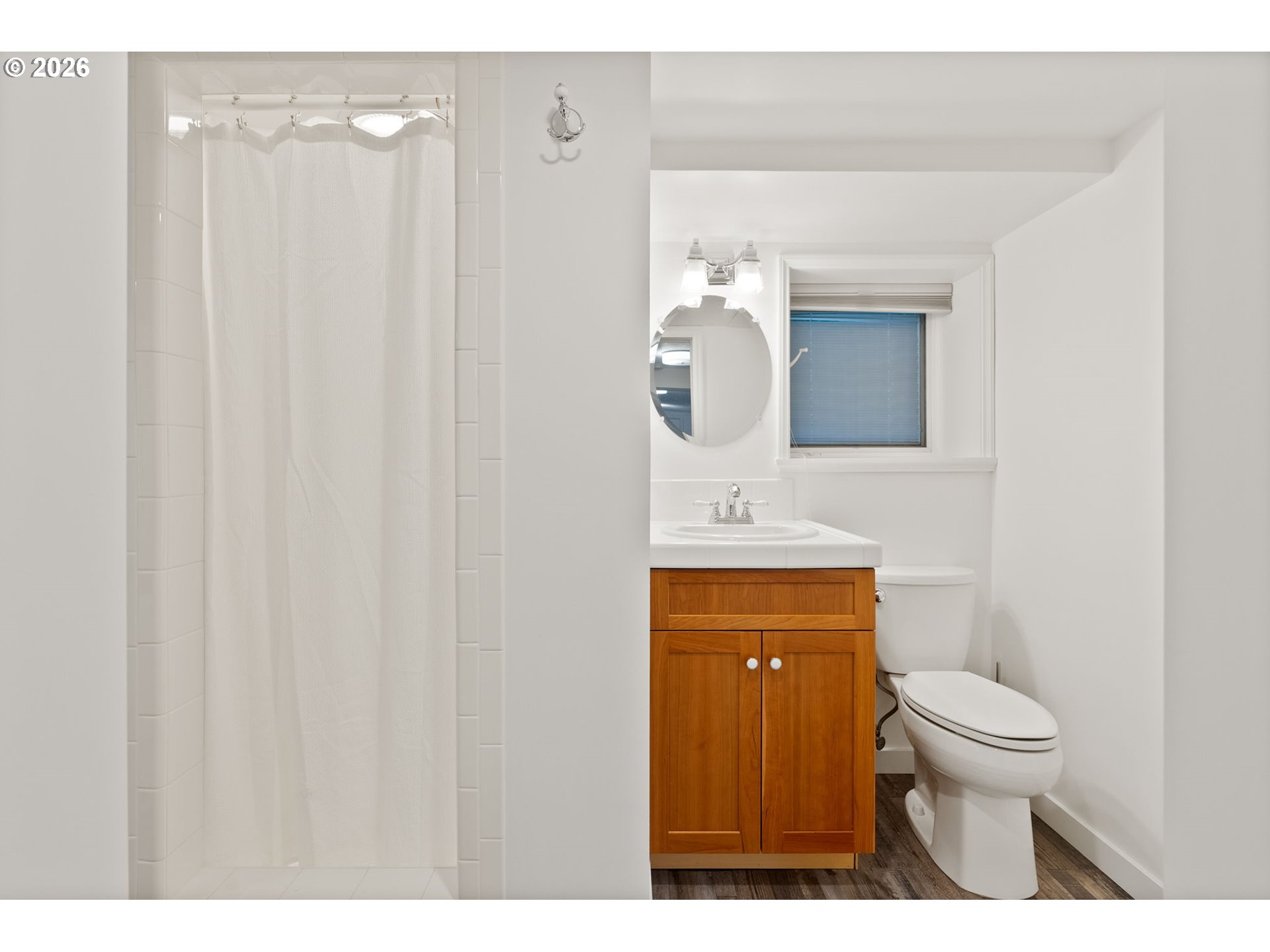 8120 Southwest Maple Drive Portland, OR 97225 - Photo 34 of 48 a bathroom with a sink a toilet and a mirror