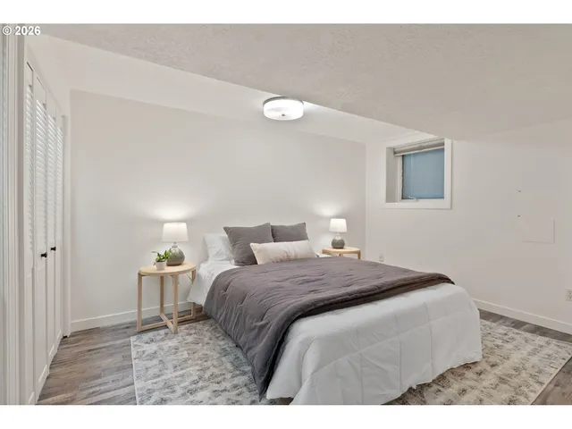 a bedroom with a bed and a lamp