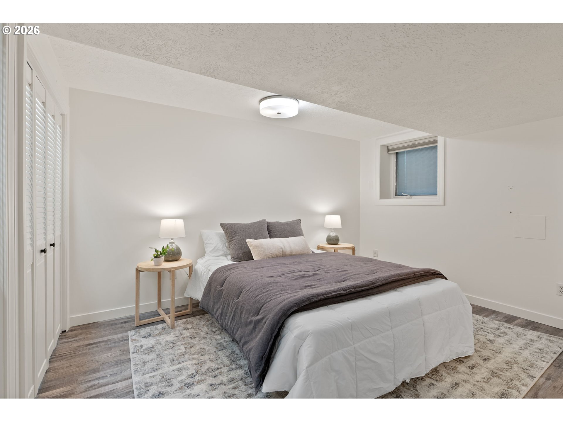 8120 Southwest Maple Drive Portland, OR 97225 - Photo 35 of 48 a bedroom with a bed and a lamp