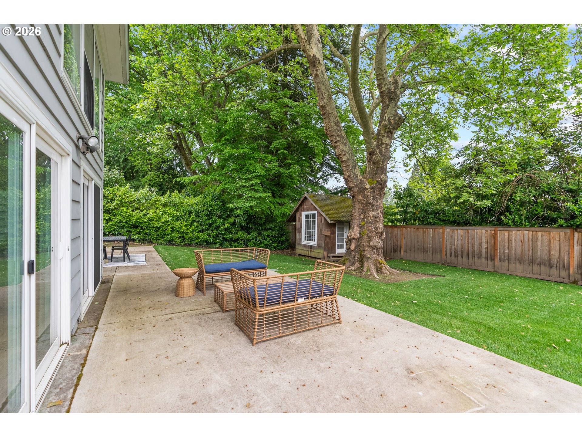 8120 Southwest Maple Drive Portland, OR 97225 - Photo 39 of 48 a view of a backyard with wooden fence and large trees