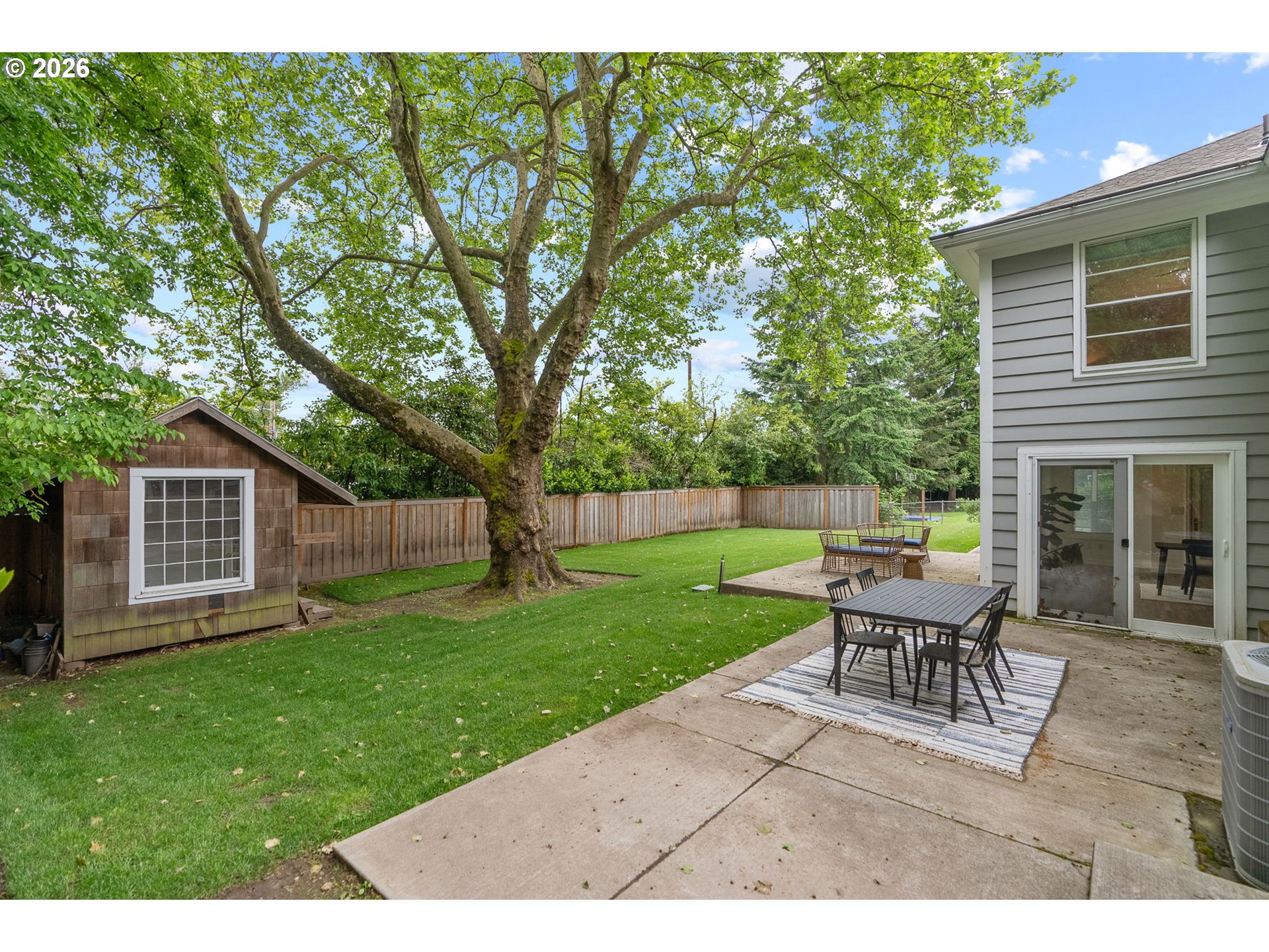 8120 Southwest Maple Drive Portland, OR 97225 - Photo 40 of 48 a backyard of a house with table and chairs