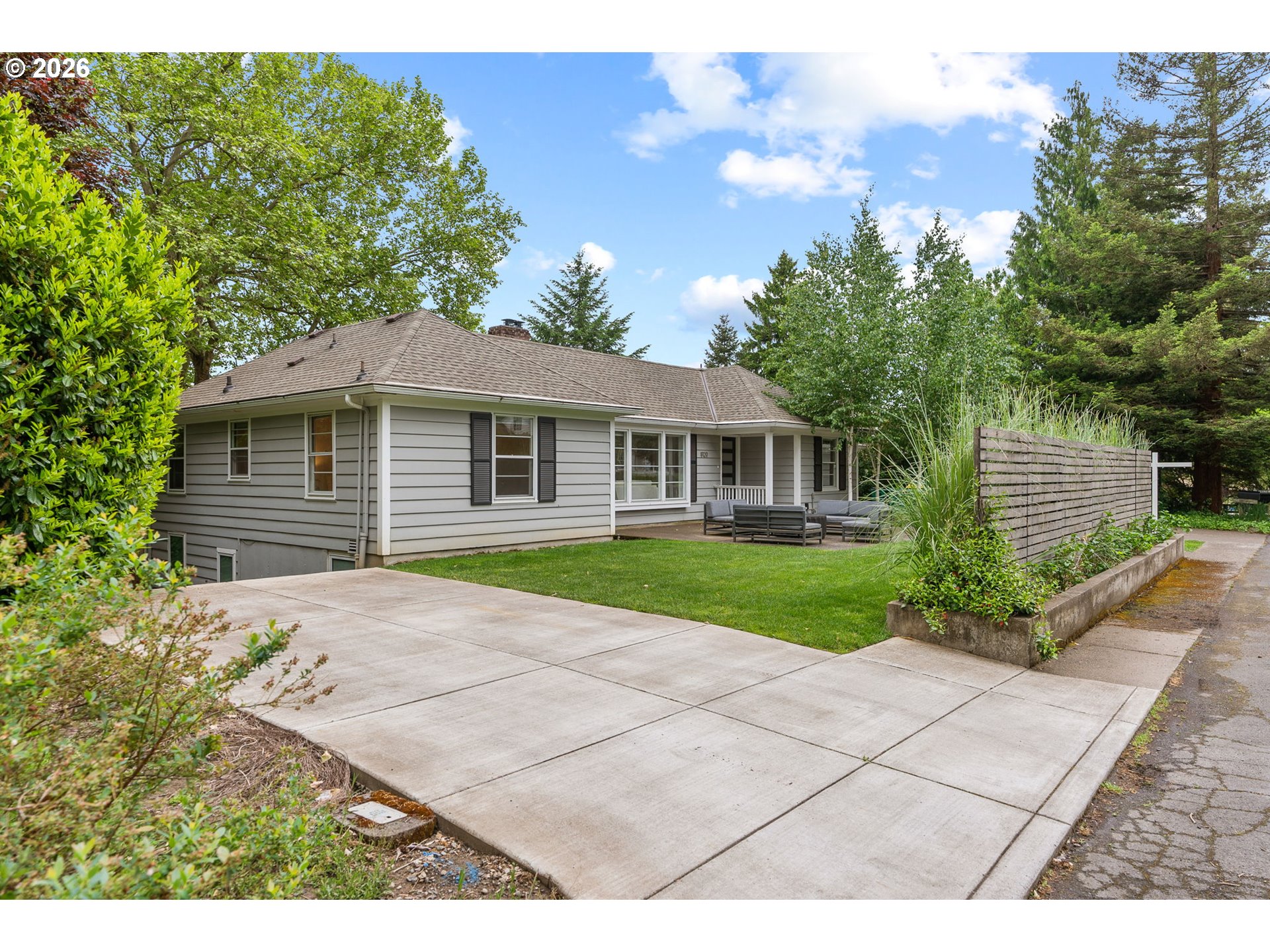 8120 Southwest Maple Drive Portland, OR 97225 - Photo 4 of 48 a front view of a house with a yard and garage