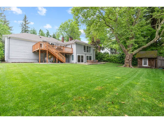 a view of a house with a yard deck and a garden