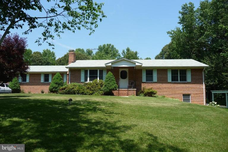 1130 Cox Road Huntingtown, MD 20639 - Photo 1 of 30 a front view of a house with a garden