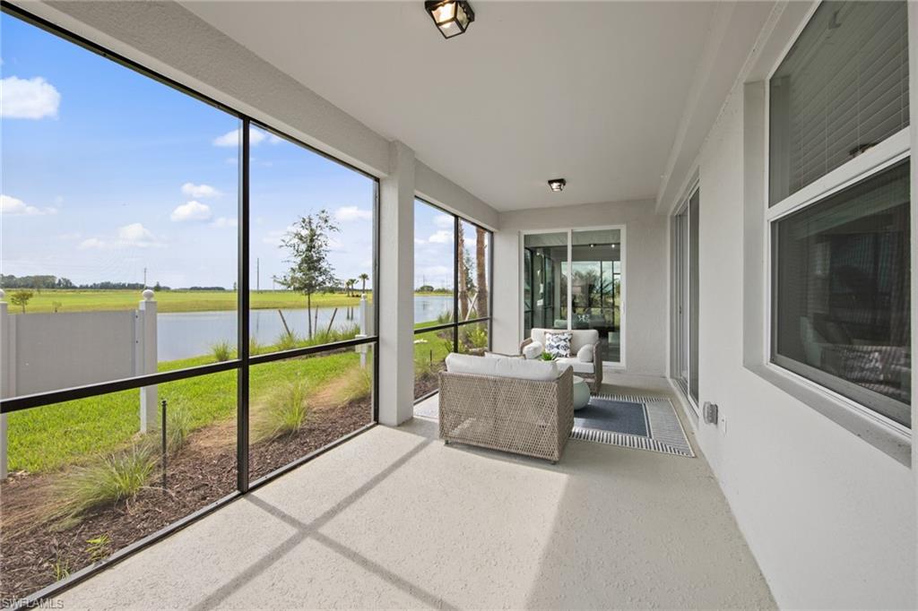 6008 Ellerston Way Avenue, Unit 1011 Immokalee, FL 34142 - Photo 18 of 50 Sunroom / solarium featuring a water view and speckled floor