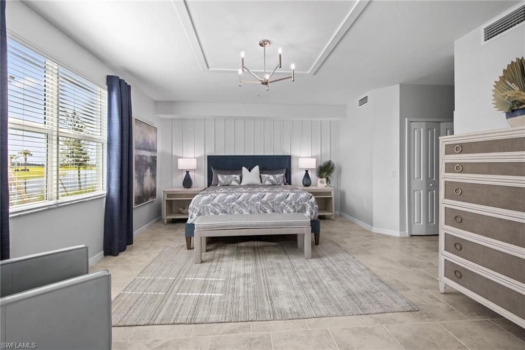 6008 Ellerston Way Avenue, Unit 1011 Immokalee, FL 34142 - Photo 23 of 50 Bedroom with a chandelier and baseboards