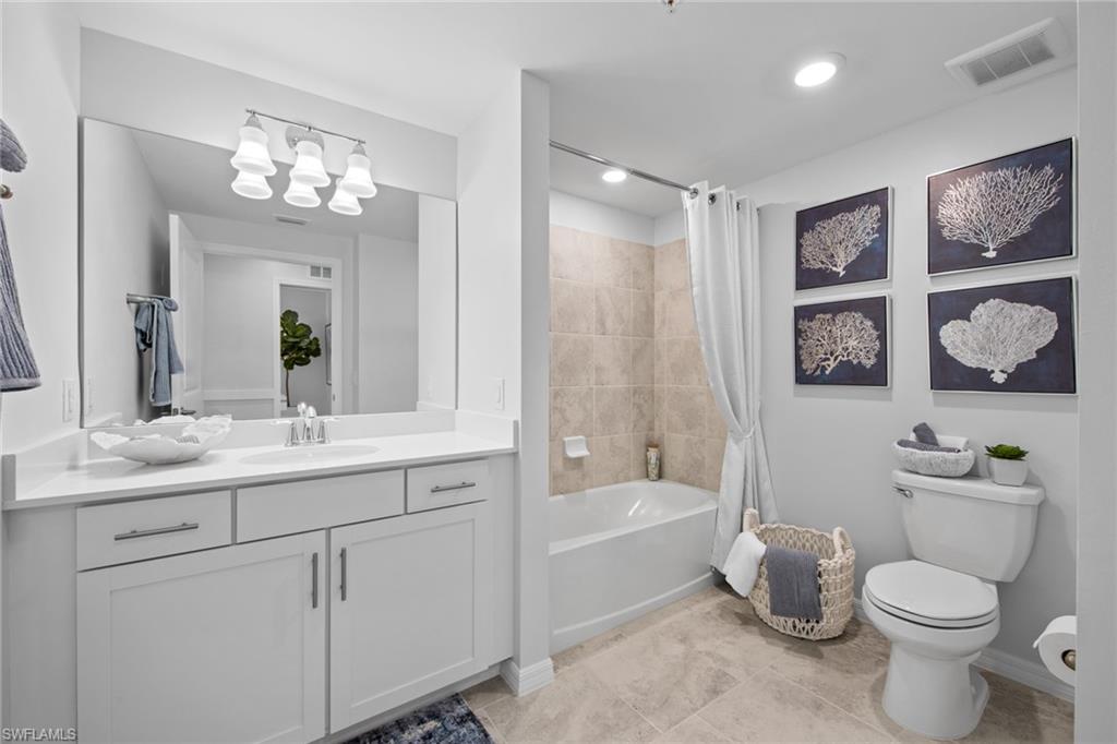 6008 Ellerston Way Avenue, Unit 1011 Immokalee, FL 34142 - Photo 31 of 50 Bathroom featuring vanity, shower / bathtub combination with curtain, light tile patterned floors, and recessed lighting