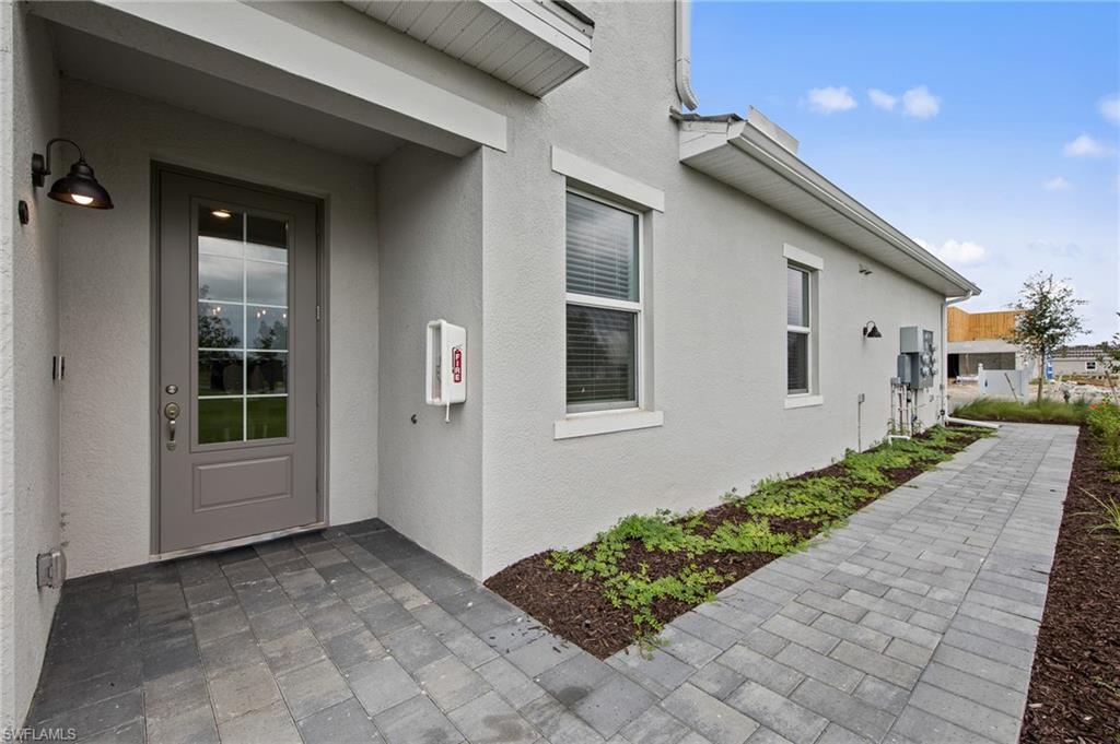 6008 Ellerston Way Avenue, Unit 1011 Immokalee, FL 34142 - Photo 33 of 50 View of exterior entry with stucco siding