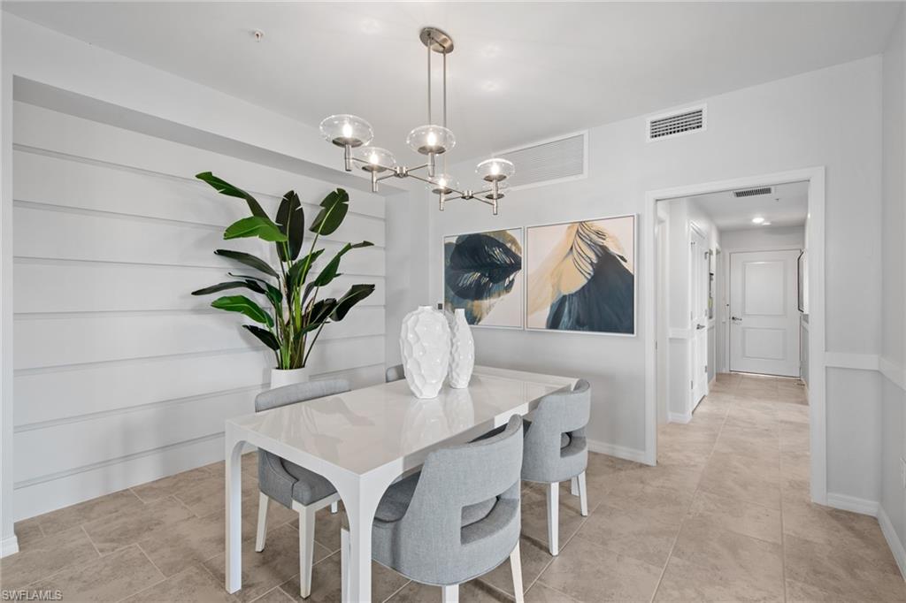 6008 Ellerston Way Avenue, Unit 1011 Immokalee, FL 34142 - Photo 10 of 50 Dining area with a chandelier and baseboards