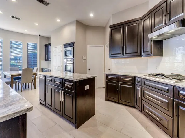 a kitchen with stainless steel appliances granite countertop a stove and a sink