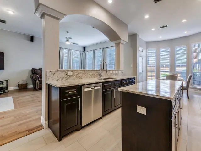 a kitchen with stainless steel appliances granite countertop a stove and a sink