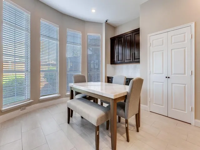 a dining room with furniture and window