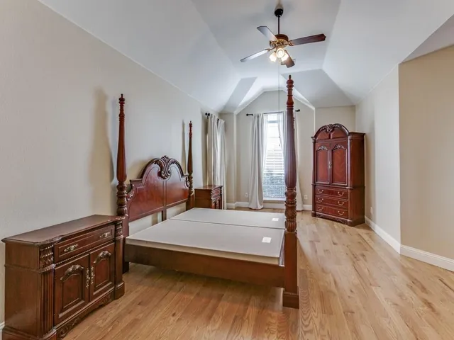 a bedroom with furniture and wooden floor
