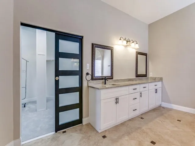a bathroom with a double vanity sink and a mirror