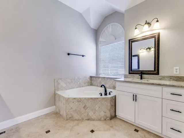 a bathroom with sink bathtub and mirror