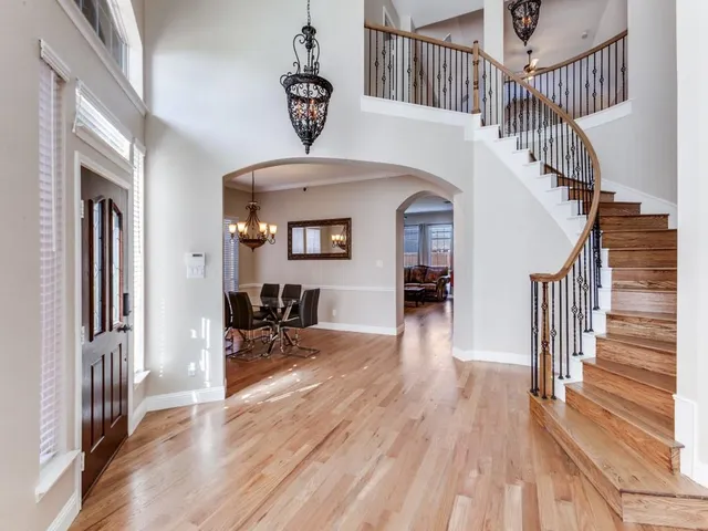 a view of entryway and hall with wooden floor