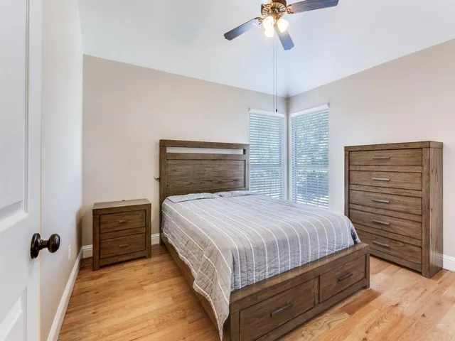 a bedroom with a bed and a chandelier