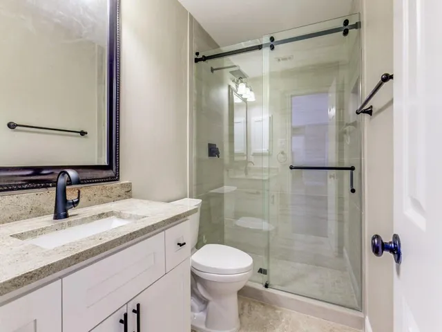 a bathroom with a sink toilet and shower