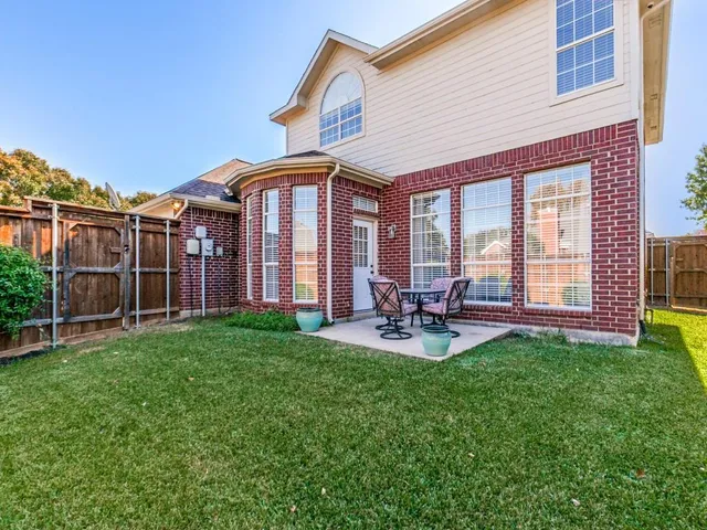 a front view of a house with patio and garden