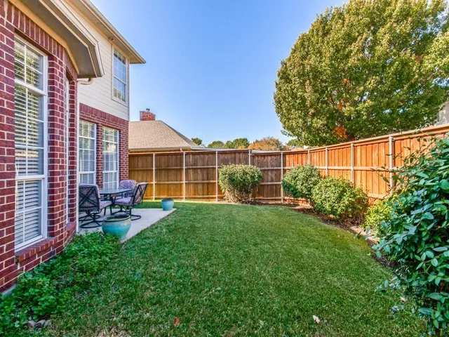 a view of a house with backyard sitting area and garden