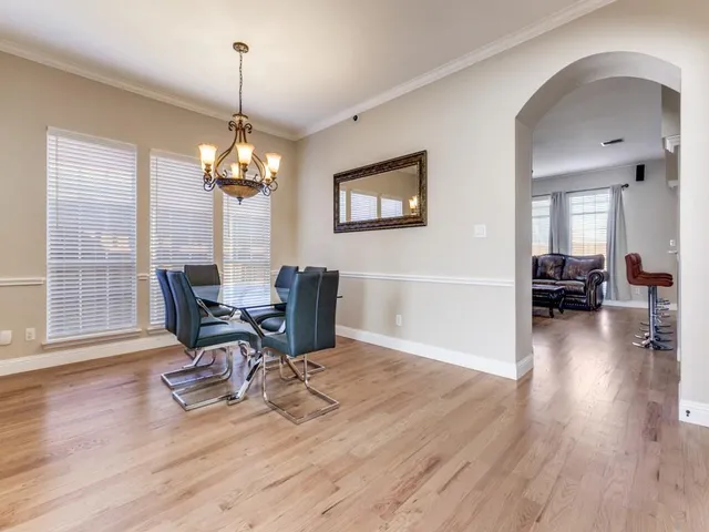 a view of a livingroom with furniture wooden floor a chandelier