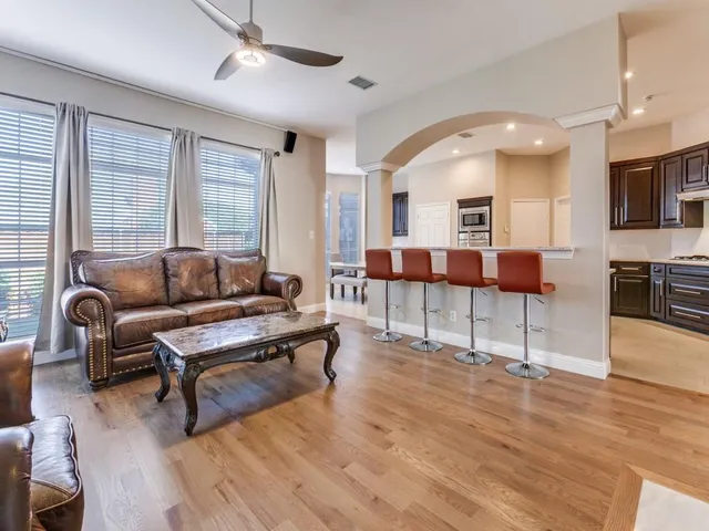 a living room with furniture and a wooden floor