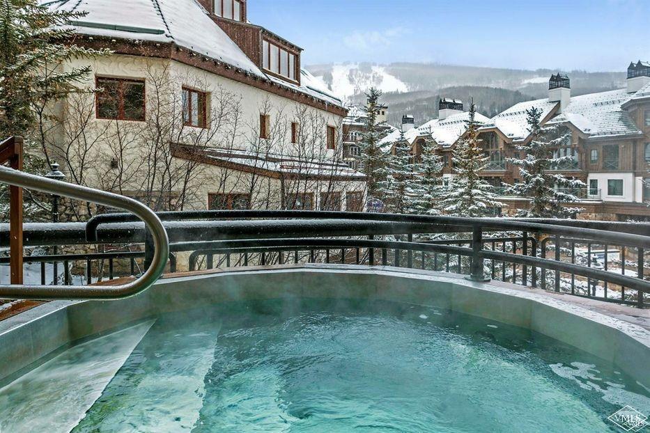 210 Offerson Road, Unit 308WEEK 51 Beaver Creek, CO 81620 - Photo 18 of 20 a view of a swimming pool with two chairs and a yard