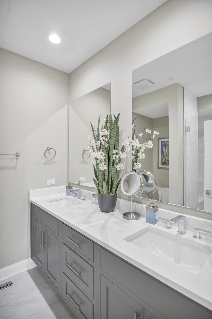 70 Prairie Court Wheeling, IL 60090 - Photo 16 of 44 a bathroom with a double vanity sink and a mirror