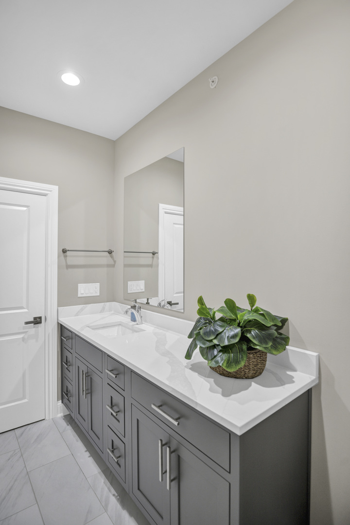 70 Prairie Court Wheeling, IL 60090 - Photo 27 of 44 a bathroom with a sink and a mirror