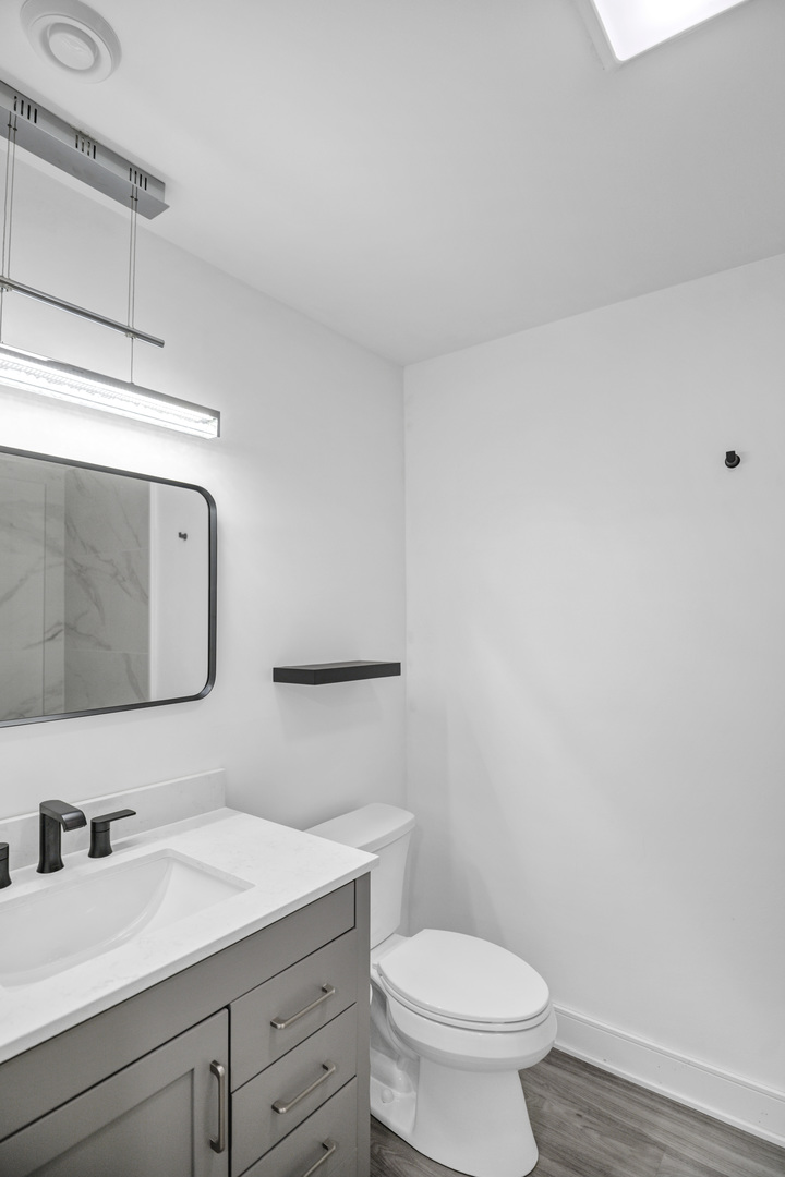 70 Prairie Court Wheeling, IL 60090 - Photo 36 of 44 a bathroom with a granite countertop toilet sink and mirror