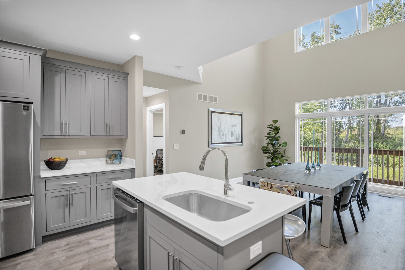 70 Prairie Court Wheeling, IL 60090 - Photo 8 of 44 a kitchen with a sink and chairs