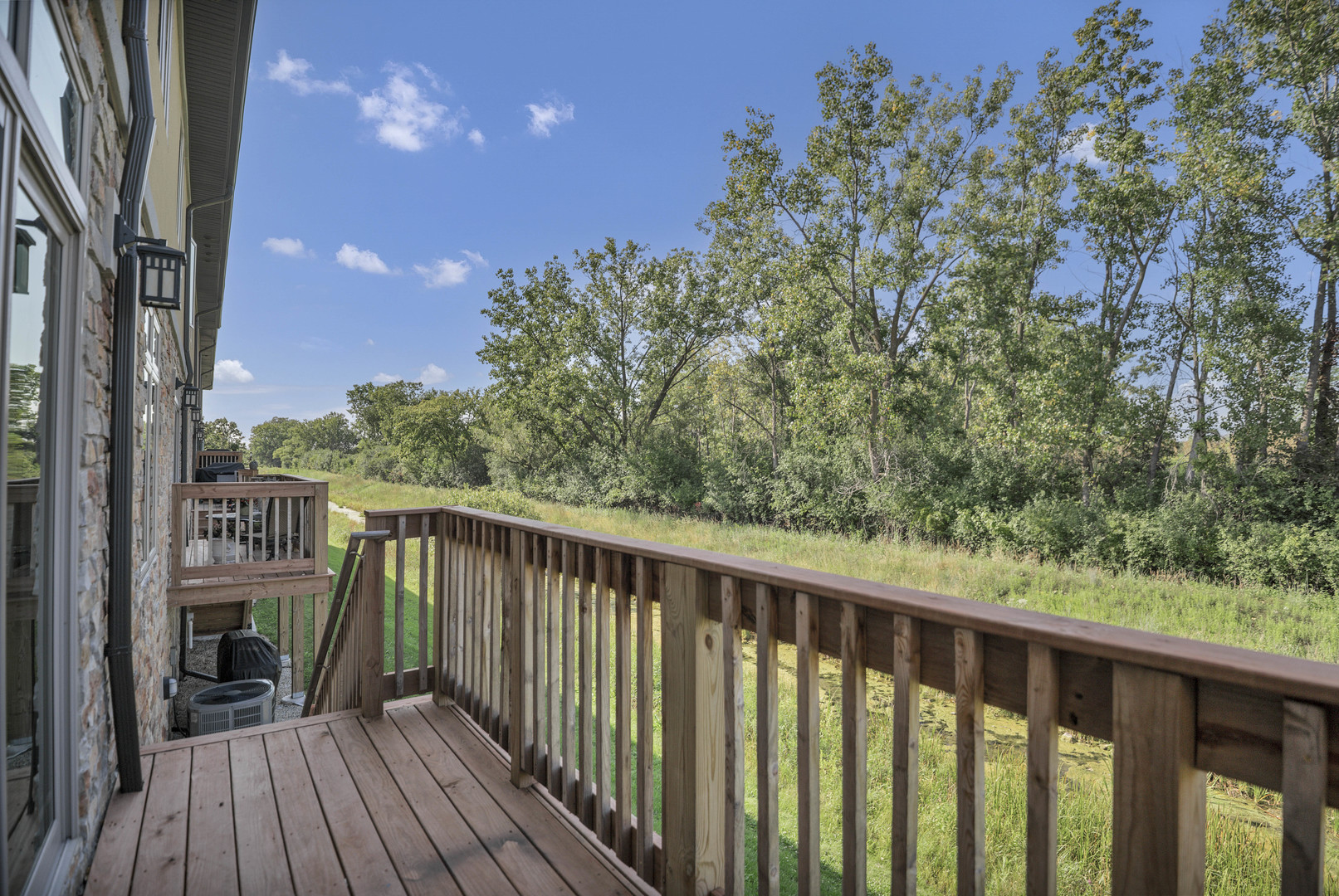 70 Prairie Court Wheeling, IL 60090 - Photo 10 of 44 a balcony with wooden floor and fence