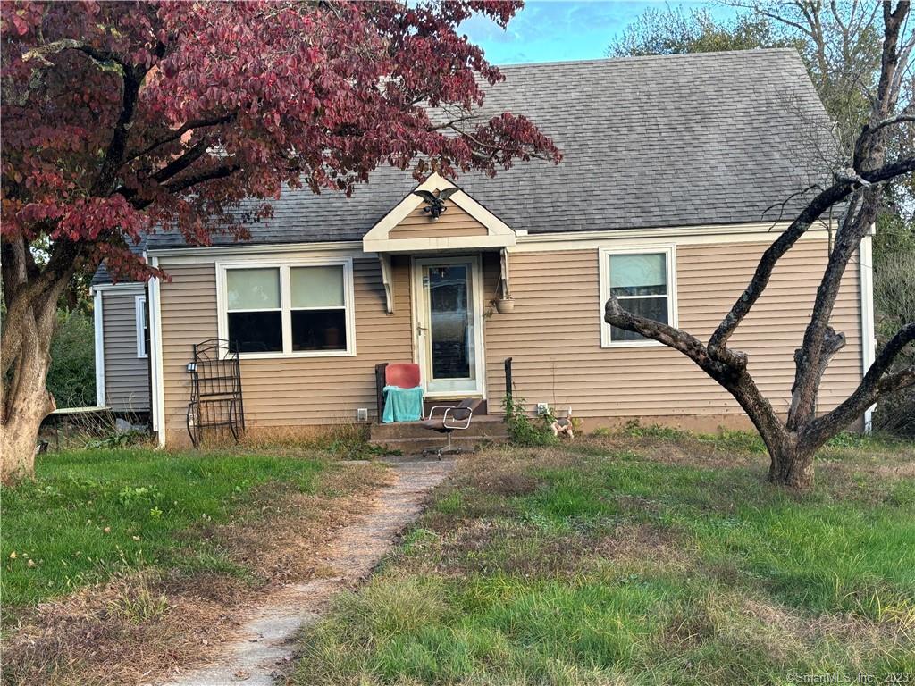 a backyard of a house with table and chairs