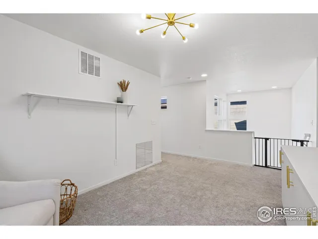 a view of a livingroom with a ceiling fan and hardwood floor