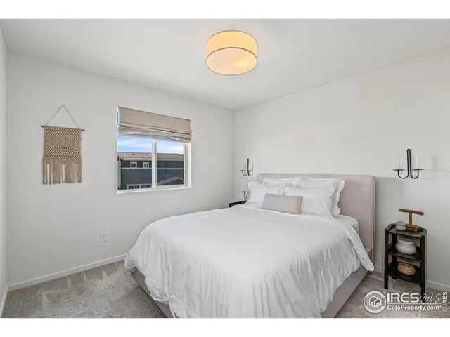 a bedroom with a bed and a lamp