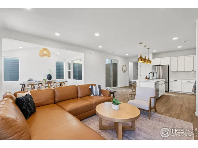 a living room with furniture and a dining table