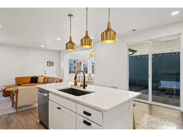 a kitchen with a sink a stove and cabinets