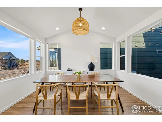 a view of dining room and kitchen with furniture wooden floor and windows